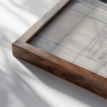 Ontwerp voor een boekband met bloemmotief 1874 Carel Adolph Lion Cachet close up dark wood mockup