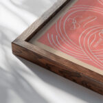 calligraphic scrolls and script on salmon background 1948 Winold Reiss close up dark wood mockup